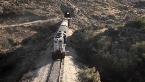 a train begins to enter into a tunnel