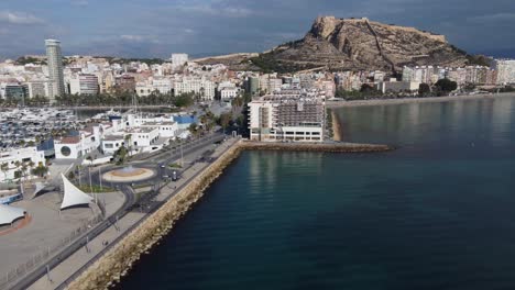 aerial view of the breakwater, hotels, santa barbara castle and postiguet beach in alicante, spain
