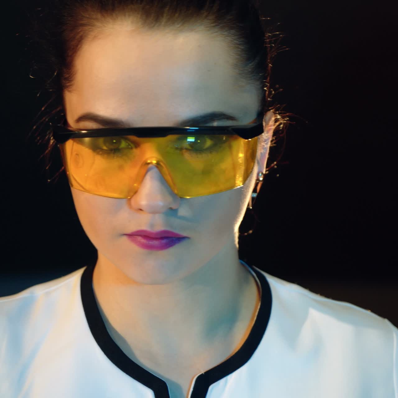 Woman scientist mixing together two liquid substances. Scientific discoveries.