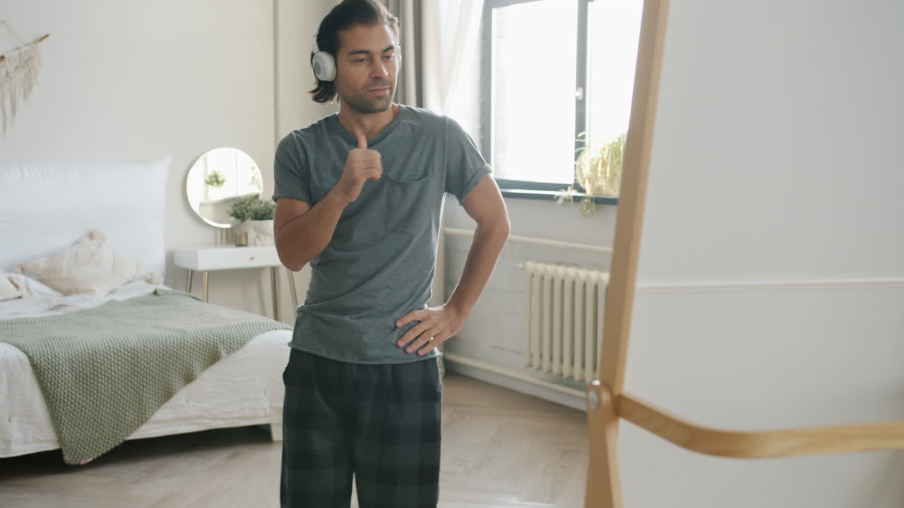 Man Dancing in Bedroom with Headphones