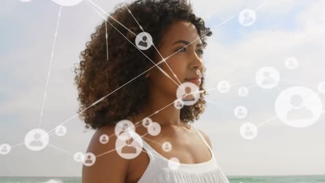 Animation-of-network-of-connections-over-woman-on-the-beach