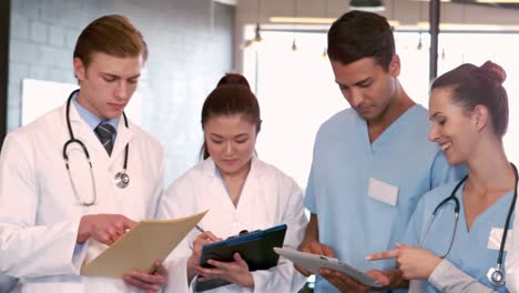 doctors and nurses writing notes on clipboards