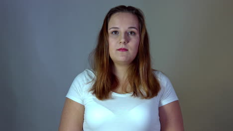 portrait of a calm overweight woman looking at the camera