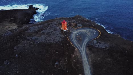 lighthouse and road on cliff near sea