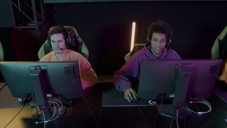 team of cybersport gamers playing video games in a gaming club