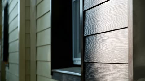 close-up of dark wood-grain siding on a house window