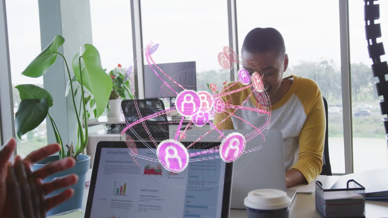 Man pointing laptop initiating network graph for business insights while colleague typing notes