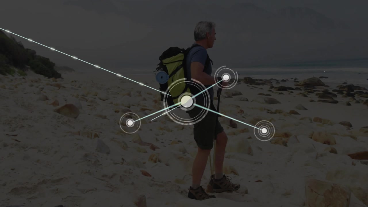 pole-using hiker advancing along rocky beach starting tech node network mapping overlaying scene
