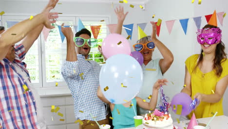 celebrating with balloons and confetti animation over people at festive party