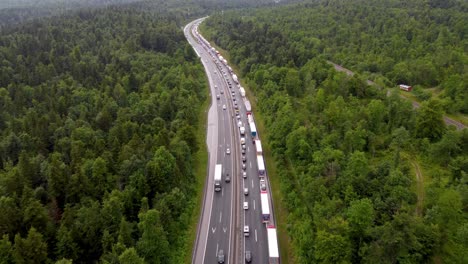 traffic congestion on national road on 2-lane highway with cars and trucks forming two lines to create an emergency lane due to traffic accident