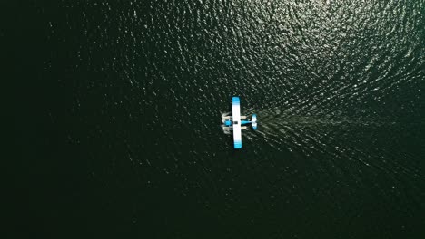 aerial top down, seaplane floating on ocean lake water