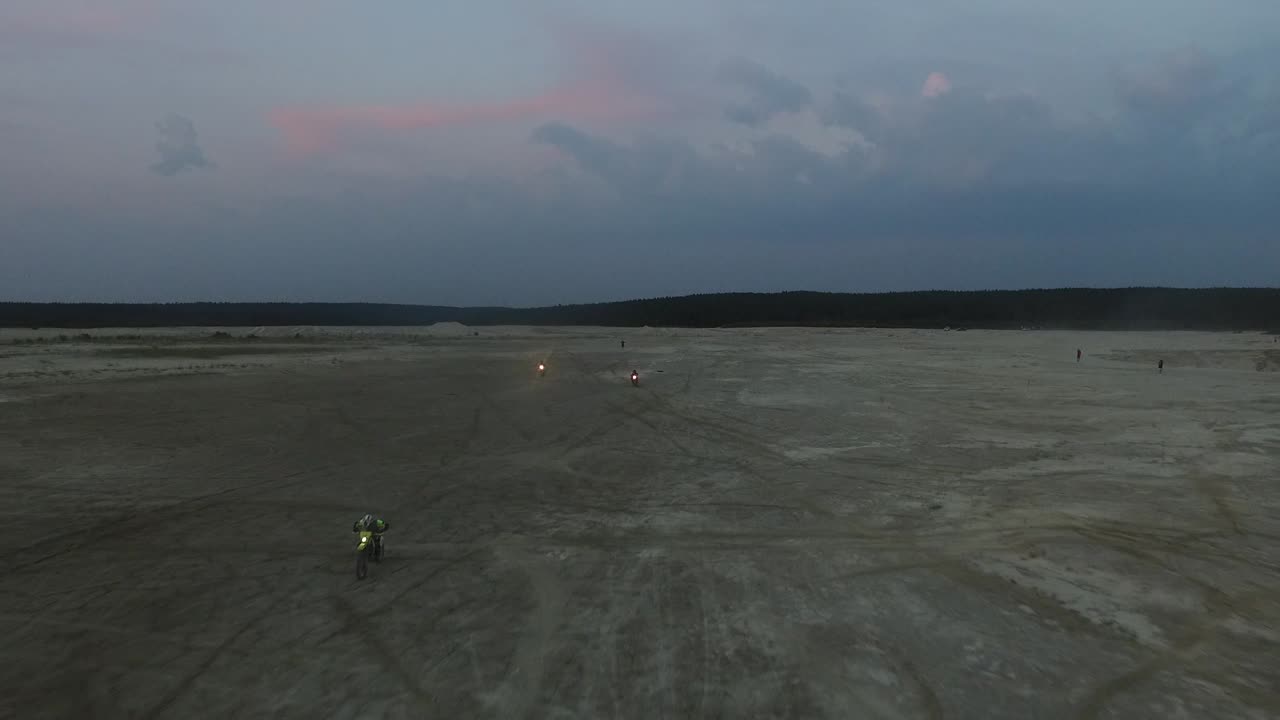 Motociclisti in un paesaggio desertico al tramonto
