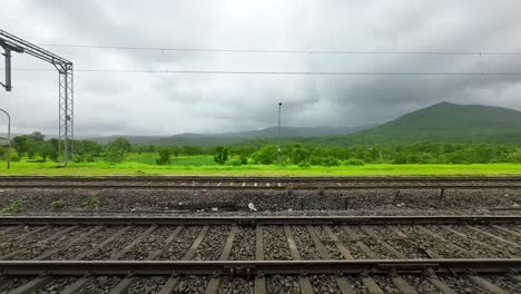 greenery forest hyper laps in rain view from train window in konkan railway