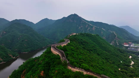 aerial view following huanghuacheng lakeside great wall, in cloudy china