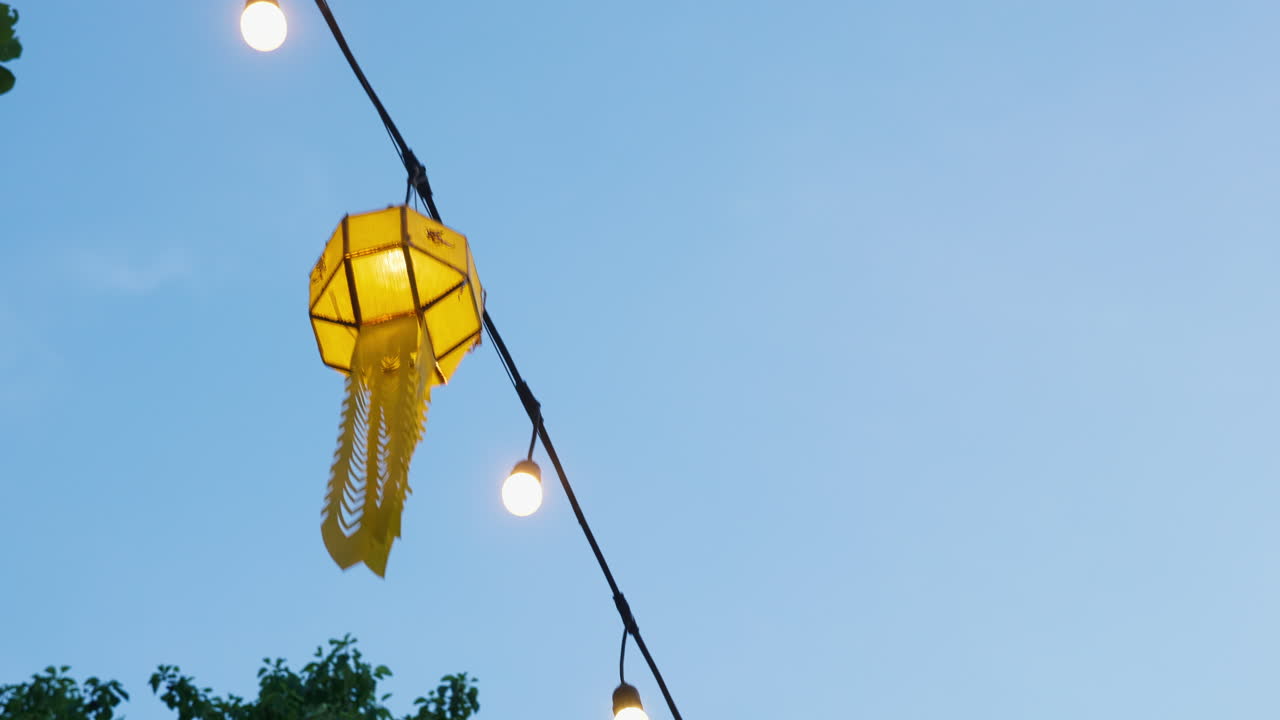Colorful Lanterns and String Lights Against a Clear Sky