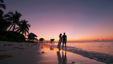 couple enjoying a romantic sunset on a tropical beach