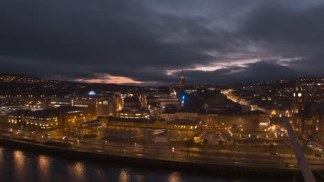 londonderry - derry - stroke city - legenderry night time aerial footage in uhd. cityscapes of the peace bridge, the foyle river, guildhall, st columb's cathedral, shipquay street, craigavon bridge