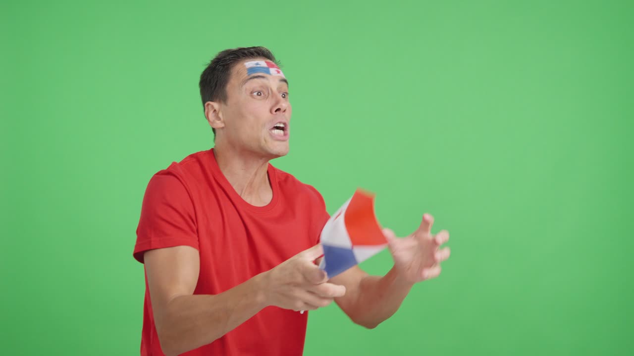Man cheering for Panama waving a national flag looking away