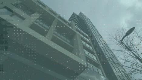 digital data patterns overlaying sky on modern high-rise building in cityscape
