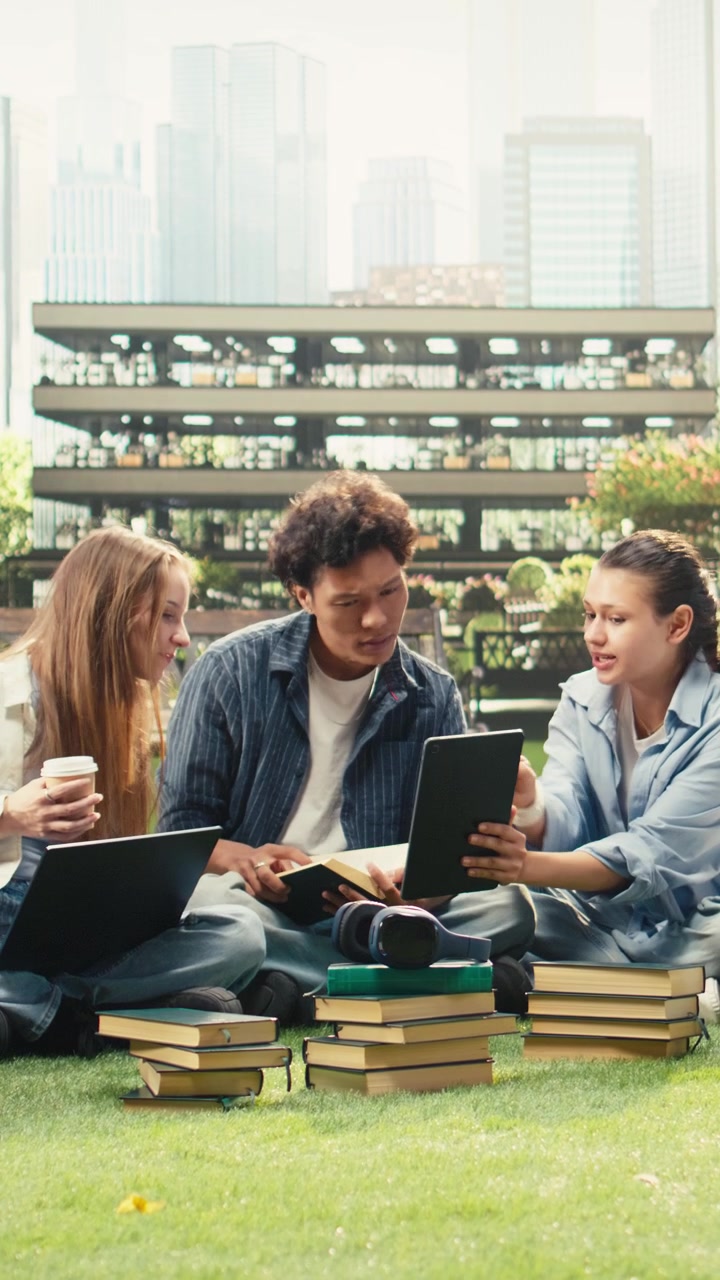 Vertical Video Woman student discussing project notes with diverse classmates near tablet