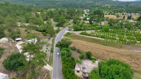 aerial view of a rural landscape with a road and village