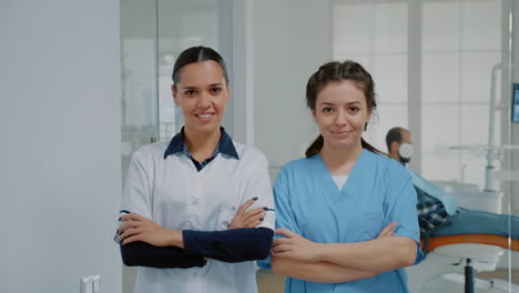 dentist and nurse in medical uniform standing at dental clinic