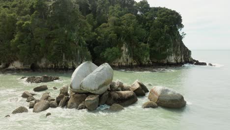 Aerial-view-rotating-around-the-geological-rock-formation-Tokangawhā-Split-Apple-Rock-in-Tasman-Bay-on-the-South-Island-of-New-Zealand-Aotearoa