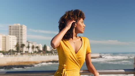 Woman-combing-her-hair-at-beach