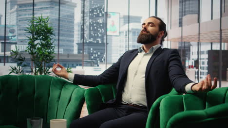 Vertical Video CEO practices mindfulness in his modern office listening to meditation music