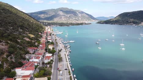 nidri bay and coastal road at lefkada island, greece - aerial forward