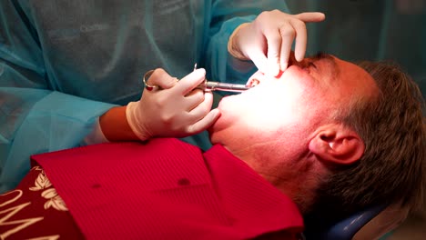 dentist injecting anesthesia into patient's mouth