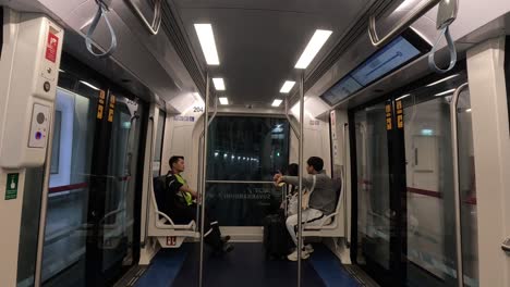 a solitary passenger rides a modern train.