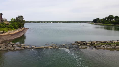 drone fly over a broken water defence or seawall showing water coming through