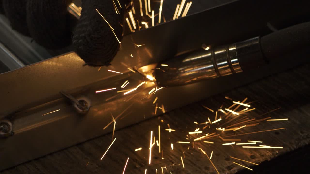 Welder works in metal construction - construction and processing of steel components, slow motion