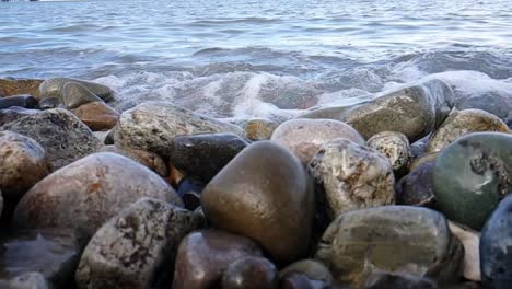 breaking sea ~ waves break over pebbles on the beach in slow motion