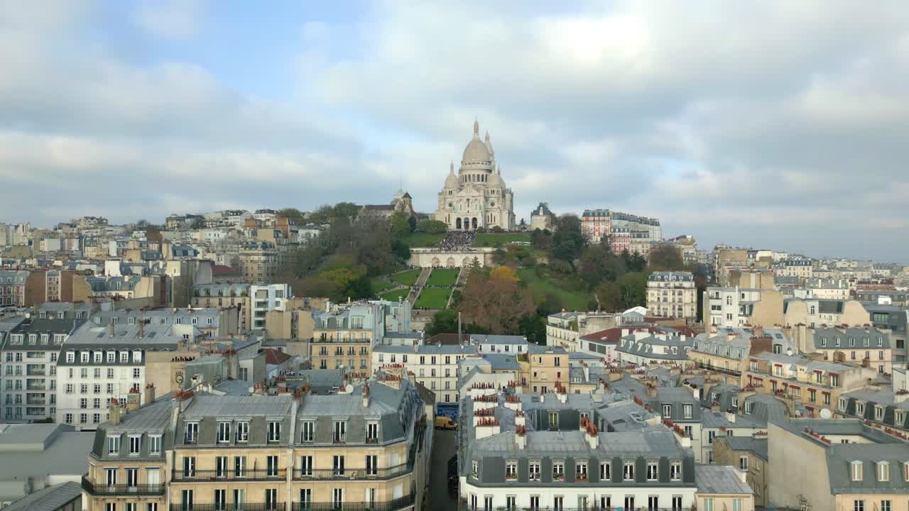 Aerial ascending over Paris city with Basilica of Sacr&eacute; Coeur or Sacred Heart of Montmartre in background