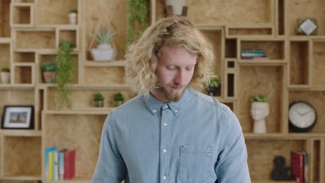 portrait of charming geeky hipster man using smart watch checking messages