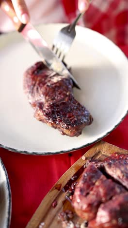 cutting into a grilled steak