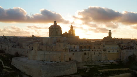 mdina city at sunset, old capital of malta country - aerial drone shot