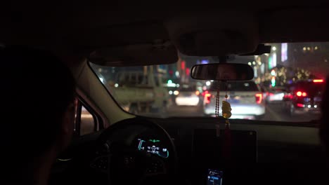 driving view from the back seat through traffic in china at night (slow motion)