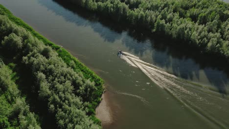 Una-Pequeña-Lancha-Motora-Que-Conduce-A-Través-De-Un-Pequeño-Corte-Rodeado-De-Hermosos-Paisajes-En-Medio-De-Un-Denso-Bosque