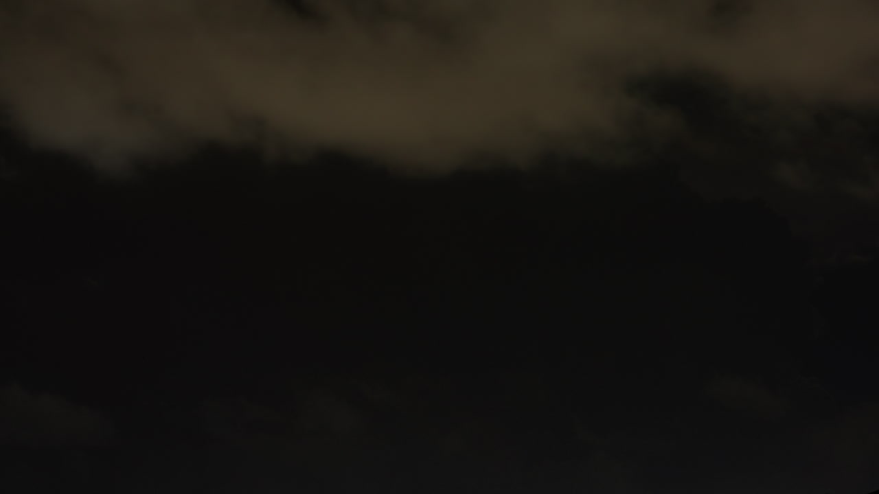 Cloudscape filled with lightning bolts and deep colors during a fierce storm