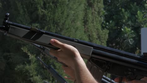 close-up of soldiers standing in a row shooting g3 assault rifles in unison