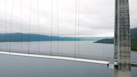 aerial: hålogaland bridge seen from the ofotfjord in narvik and some cars crossing it