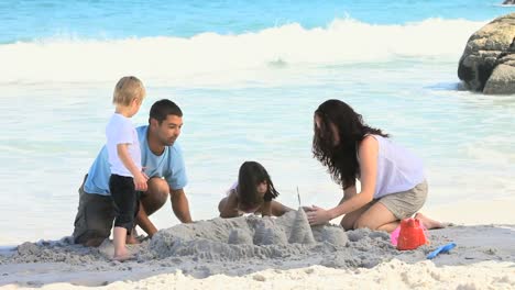 family building a sand castle