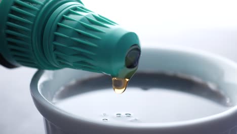 bottle of maple syrup pouring close up