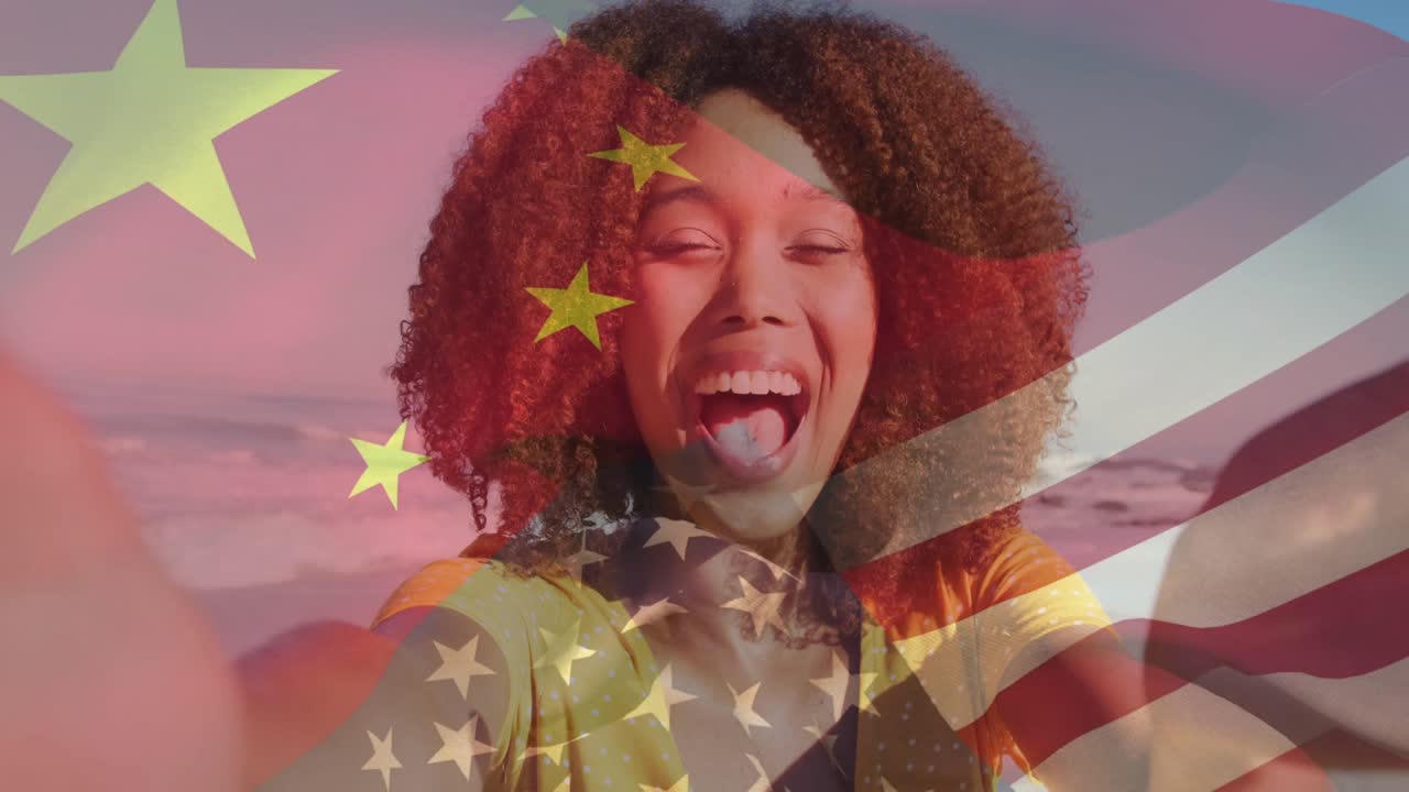 Woman blowing kiss filming social media at beach, causing stars to merge into stripes over face