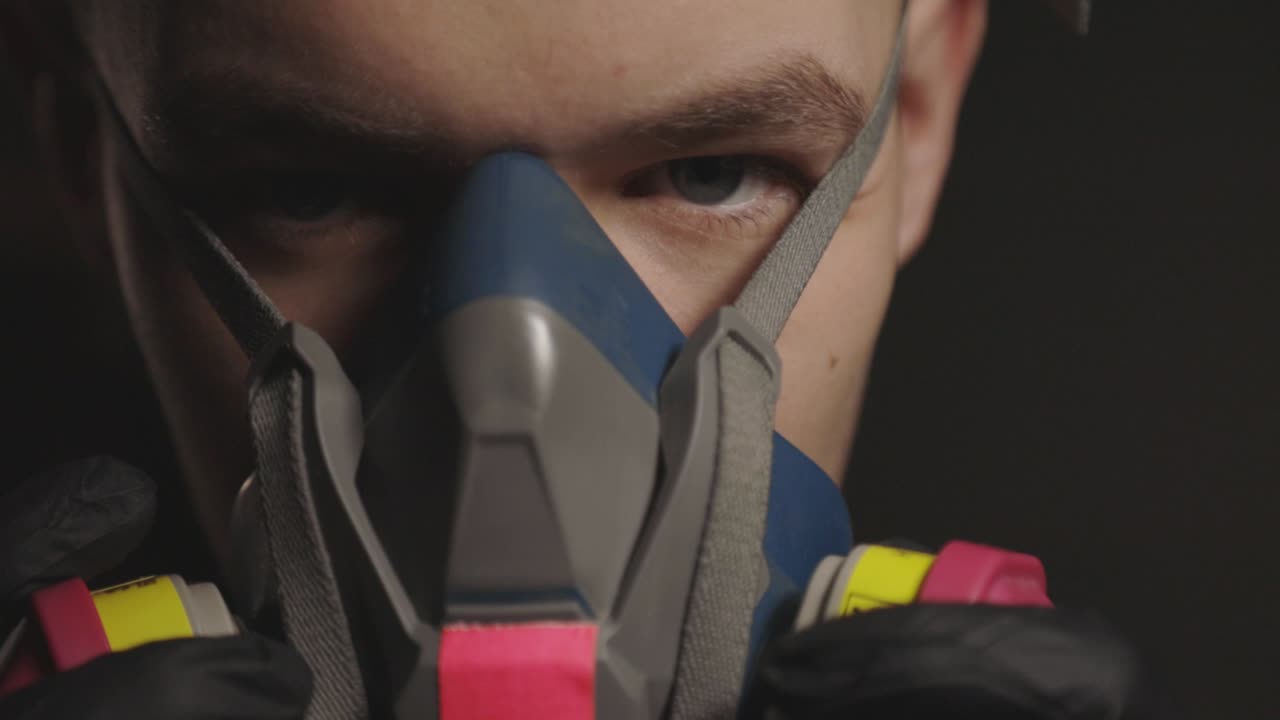 A Young Man Removing Slowly A Mask Device - Close-up Shot