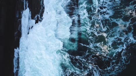 Aerial-view-of-waves-hitting-the-rocks-in-Curtis-island-lighthouse-Camden-Maine-USA