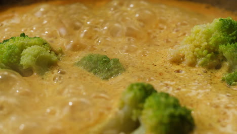 cooking thai curry with broccoli
